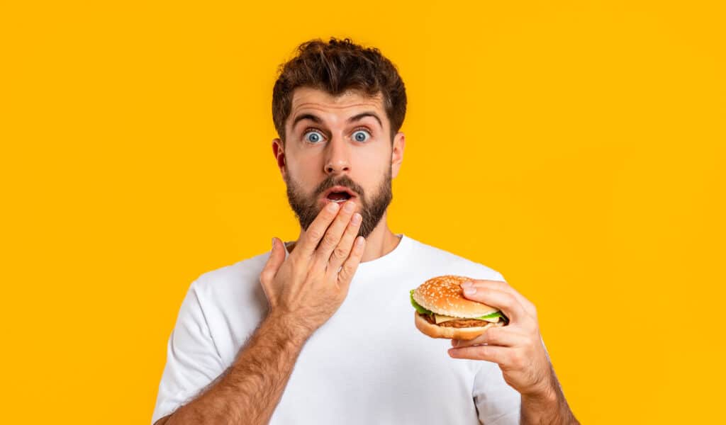 OopsCheatMealPortraitOfFunnyShockedYoungGuyEating | GroupOne Services