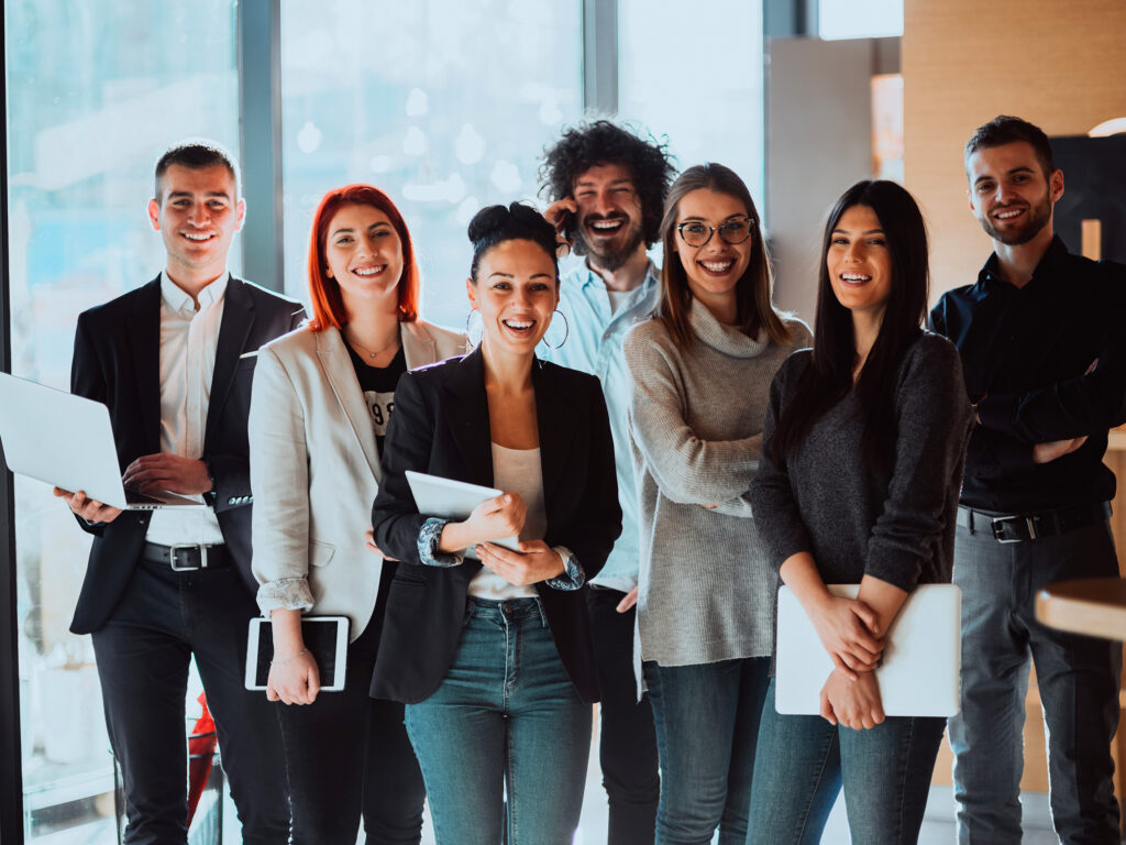 GroupOfSuccessfulBusinessPeopleStandingTogetherAtOffice | GroupOne Services