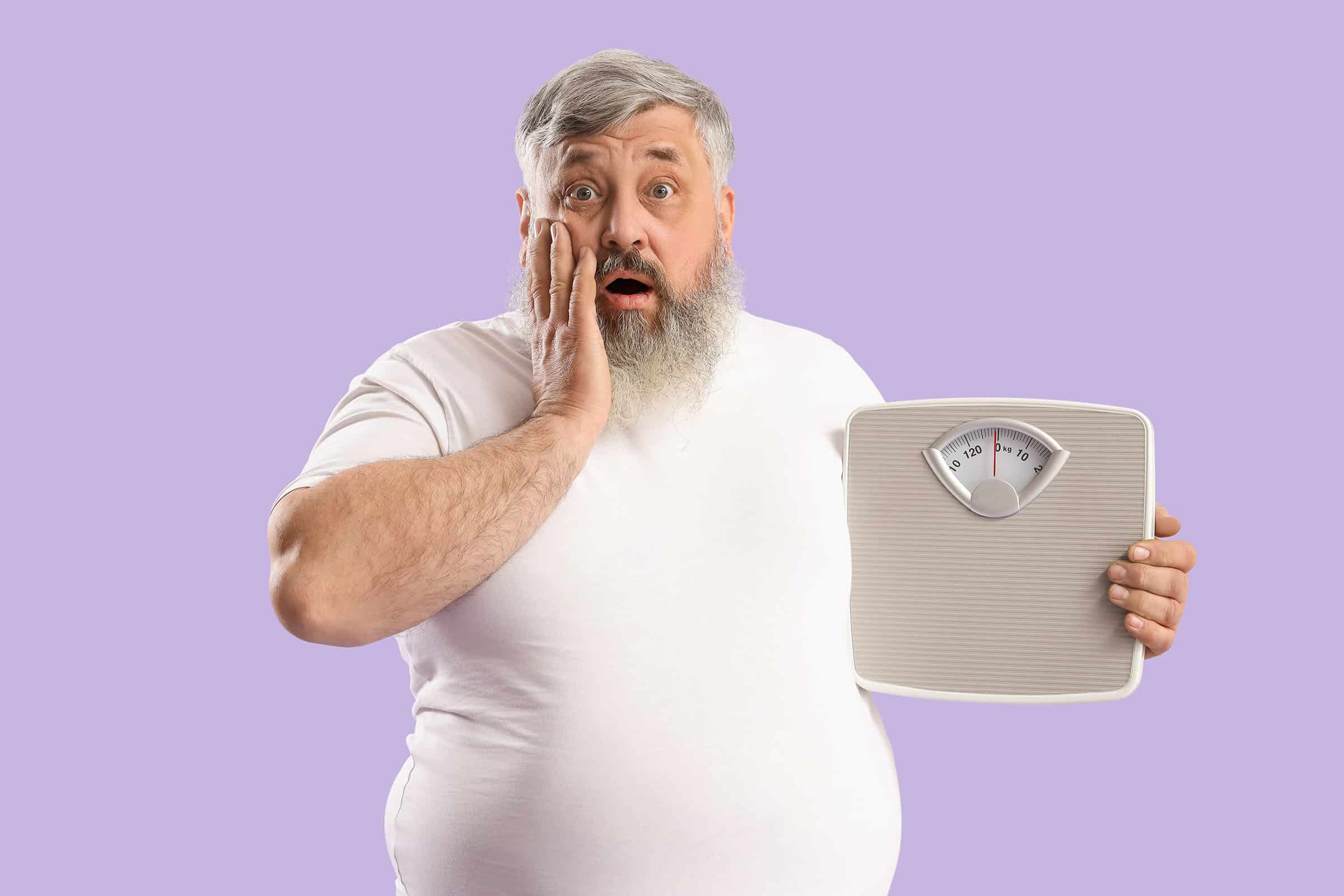 Man with surprised expression holds a vintage kitchen-scale, against a lavender background.